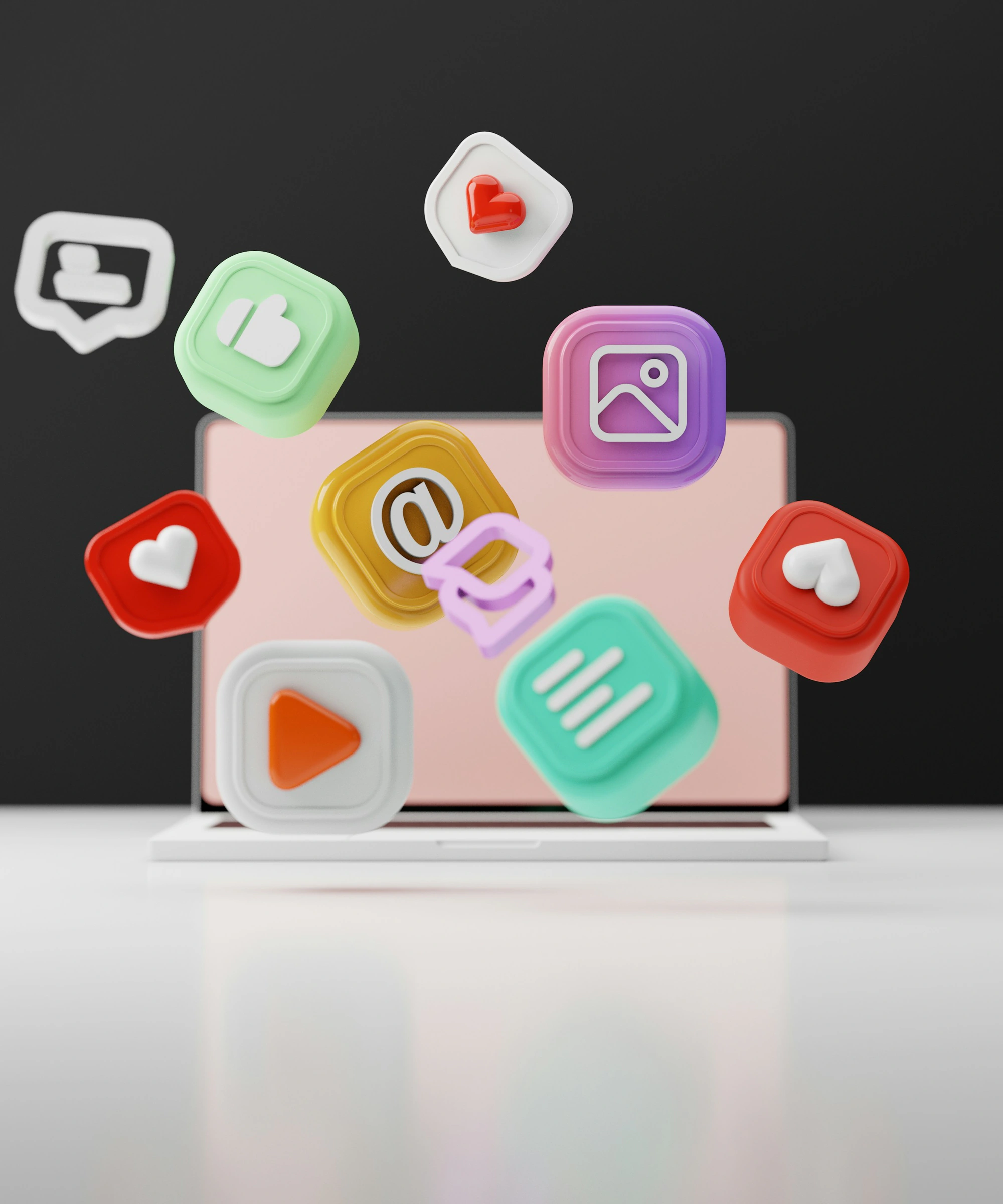 Colourful social-media, message and notification icons floating in front of a laptop