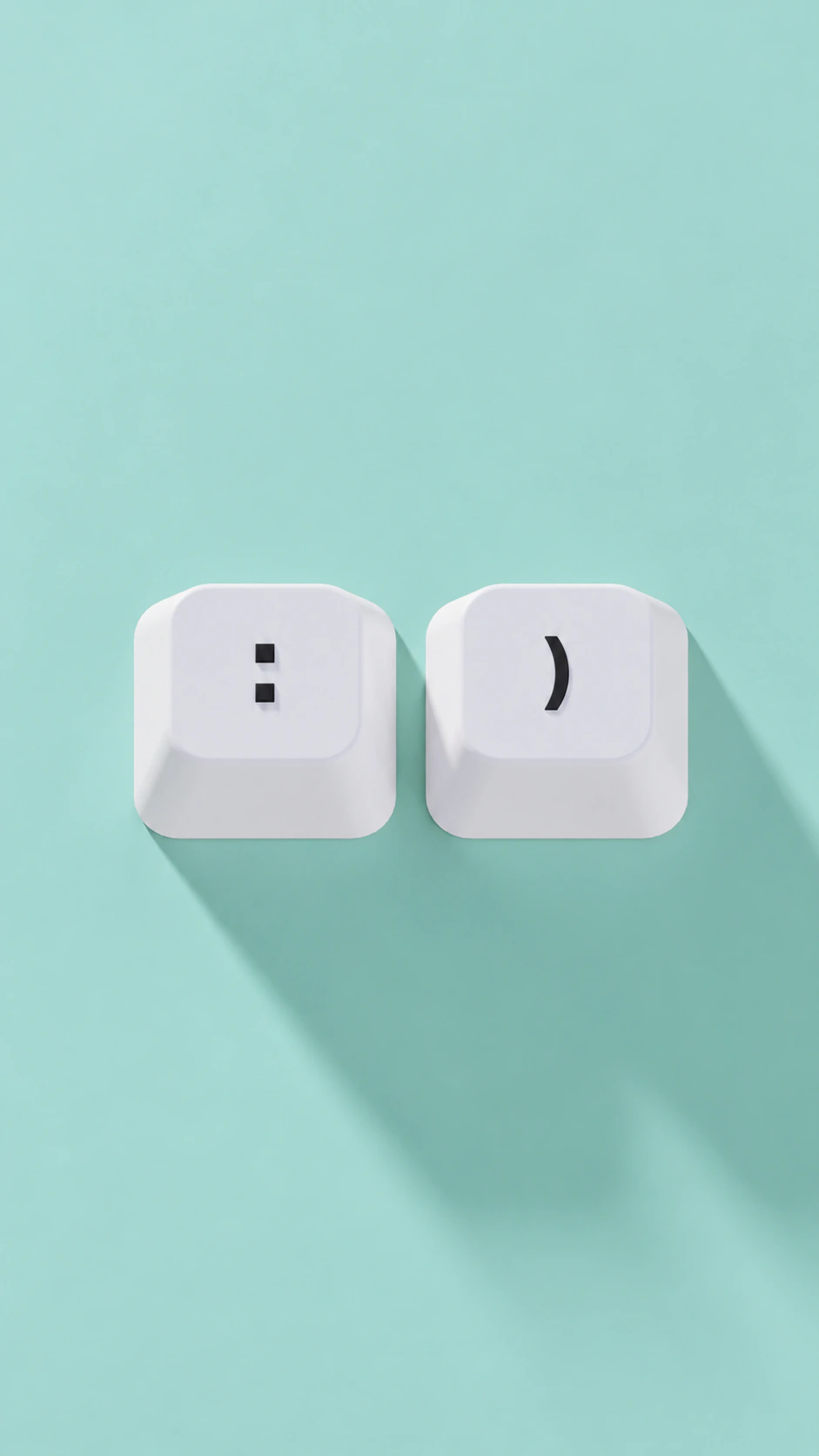 Two white keyboard keys forming a smile on a mint green background